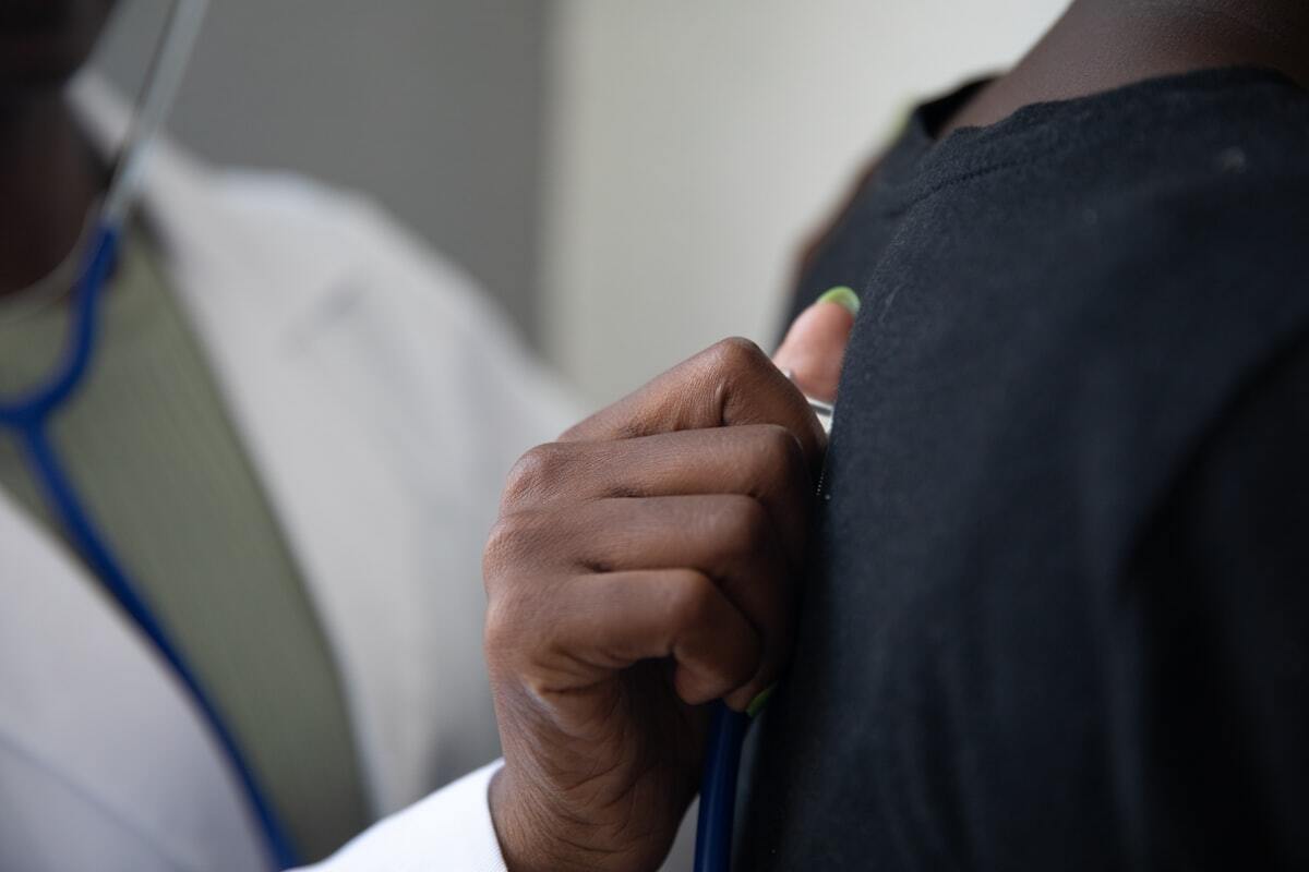 Clinician holding a stethoscope, close up